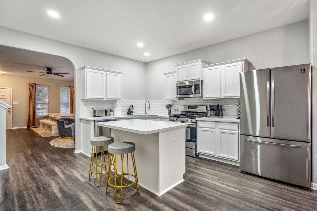 Step into our stylish kitchen, featuring sleek finishes, high-end appliances, and a breakfast bar for casual dining.